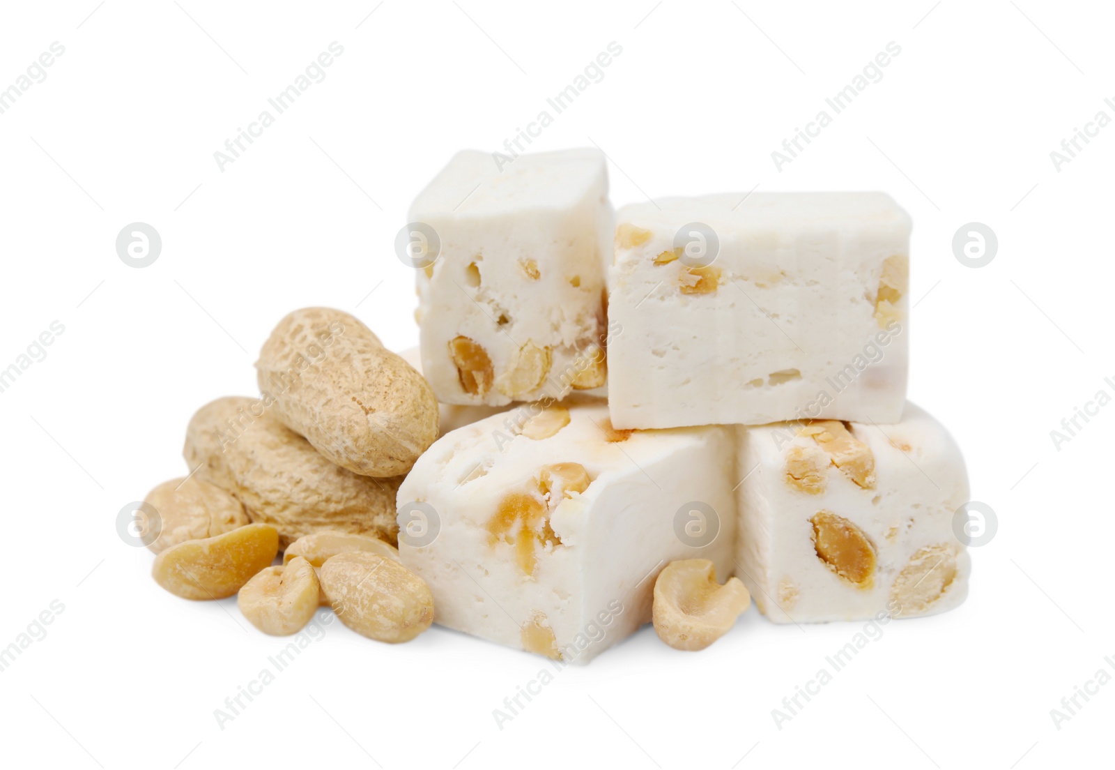 Photo of Pieces of delicious nougat and nuts on white background