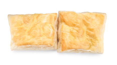 Photo of Delicious fresh puff pastries isolated on white, top view