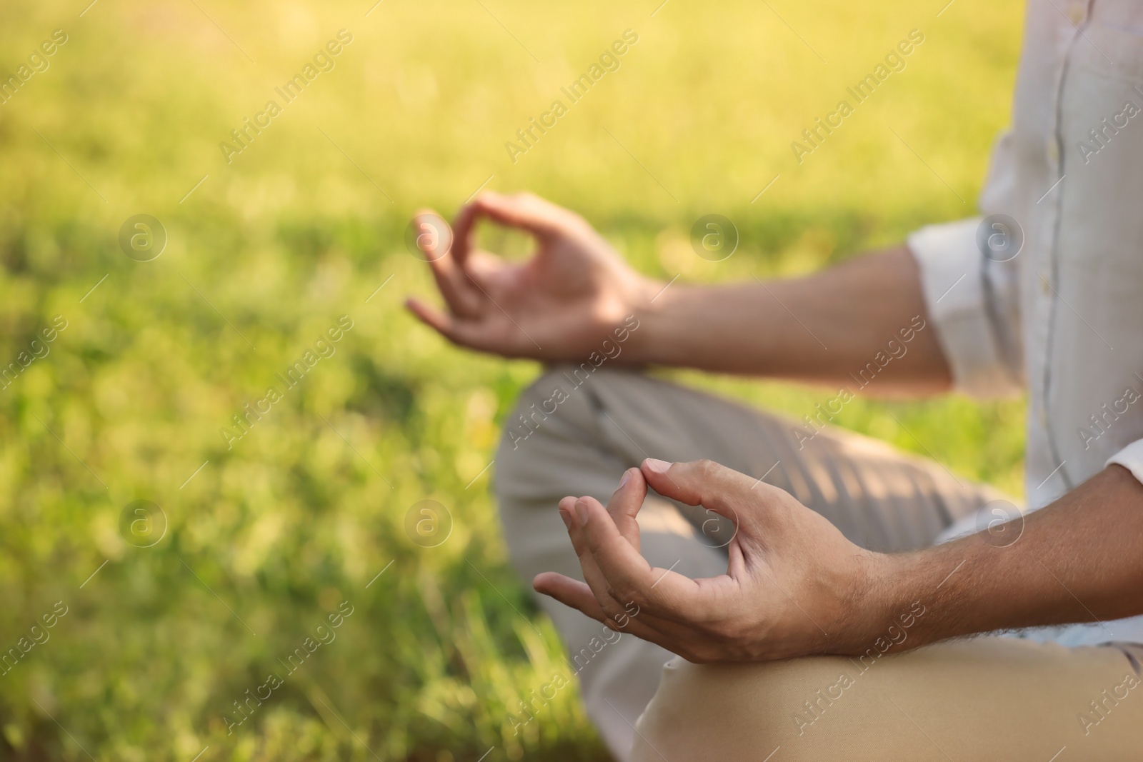 Photo of Man meditating outdoors on sunny day, closeup. Space for text