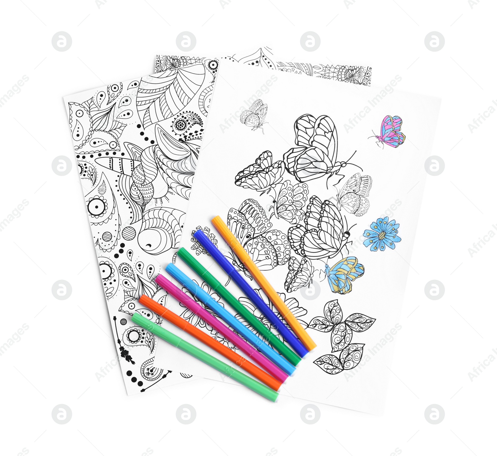 Photo of Antistress coloring pages and felt tip pens on white background, top view