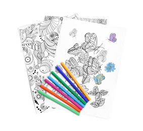 Antistress coloring pages and felt tip pens on white background, top view