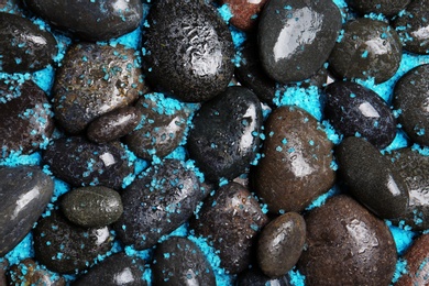 Photo of Composition with spa stones and sea salt as background, top view