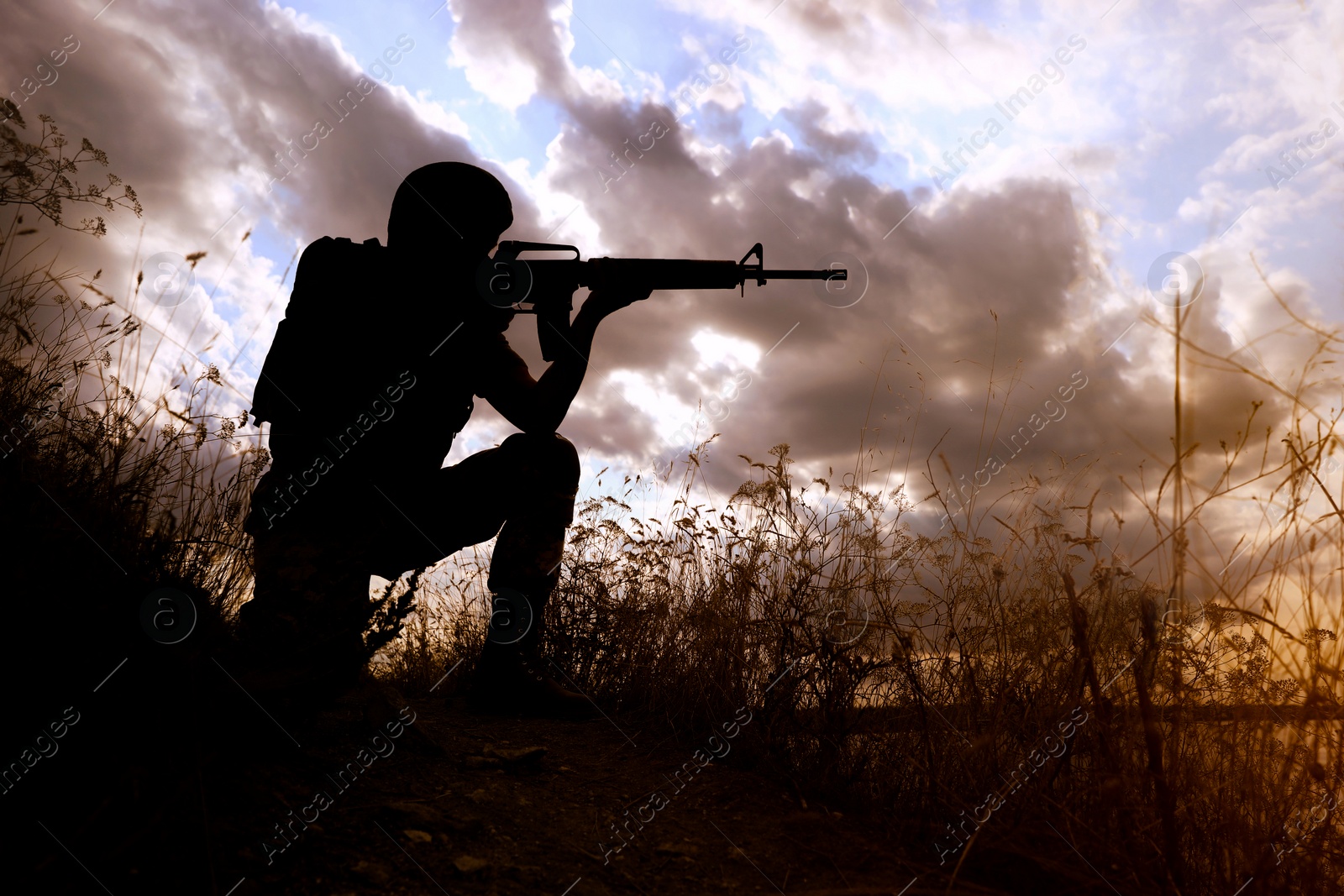 Photo of Soldier with machine gun patrolling outdoors. Military service