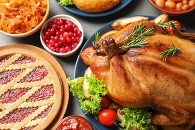 Photo of Delicious roasted turkey on festive table, closeup
