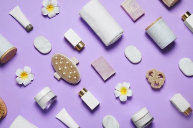 Photo of Spa essentials on violet background, flat lay