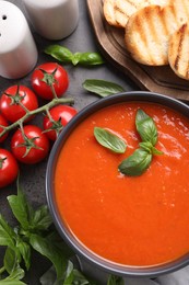 Photo of Flat lay composition with delicious tomato cream soup in bowl on grey table