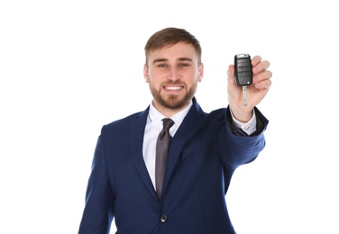 Photo of Happy young businessman with car key on white background