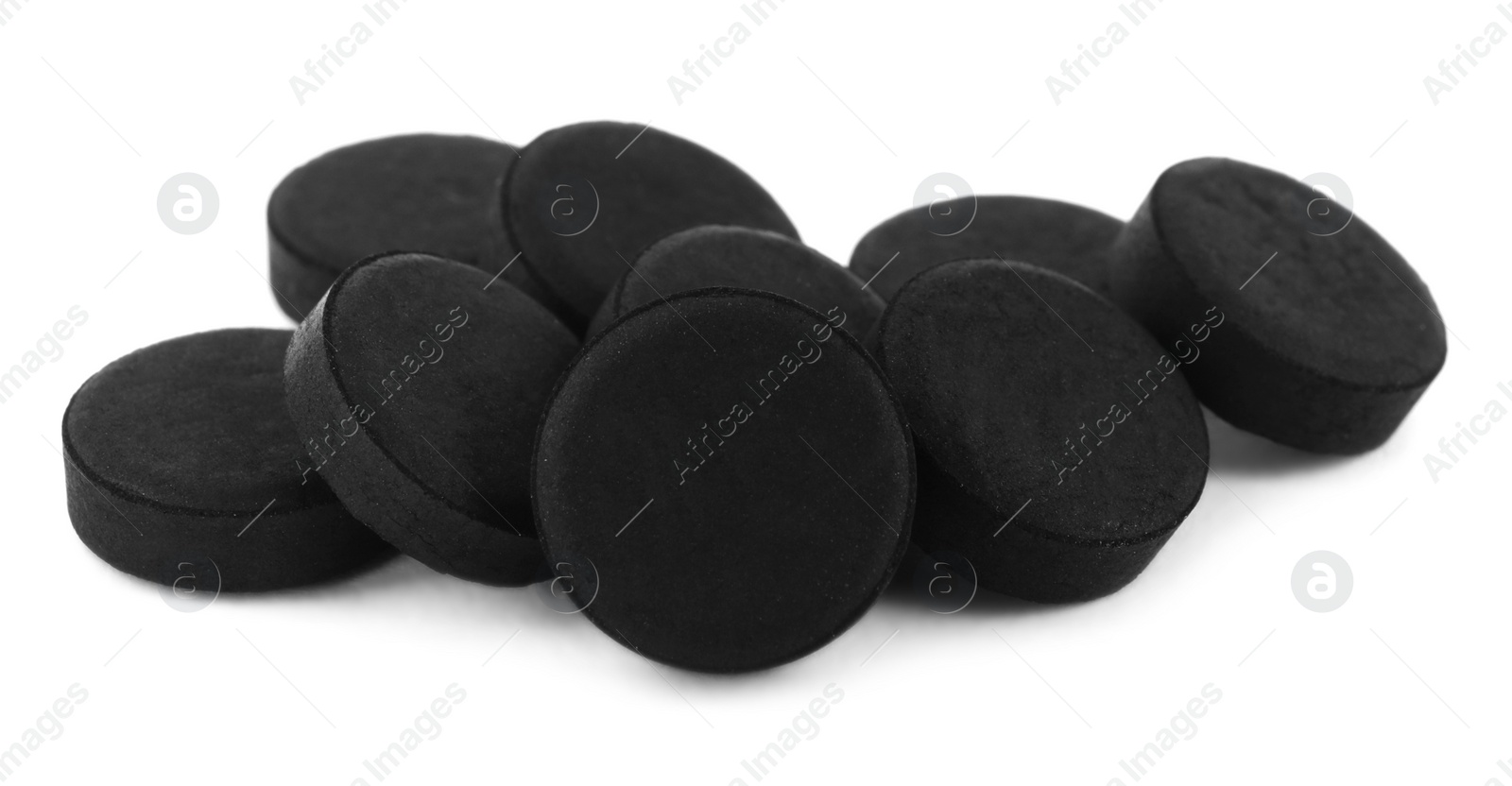 Photo of Activated charcoal pills on white background. Potent sorbent