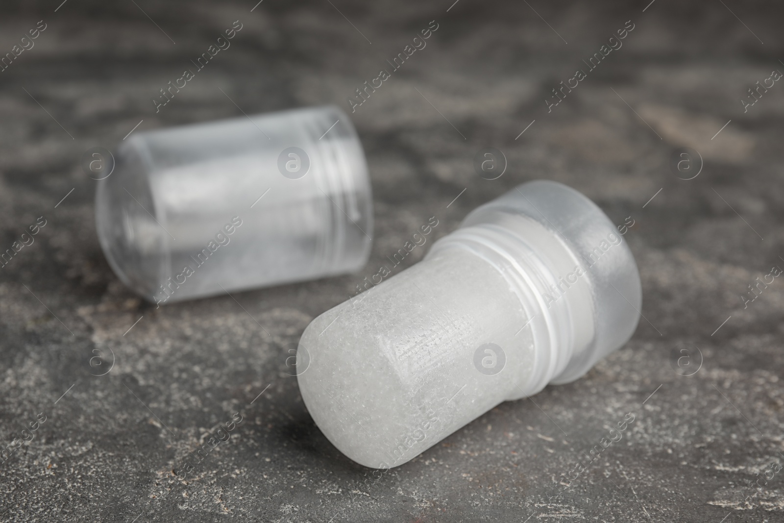 Photo of Natural crystal alum deodorant and cap on grey table