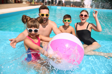 Photo of Happy family having fun in swimming pool