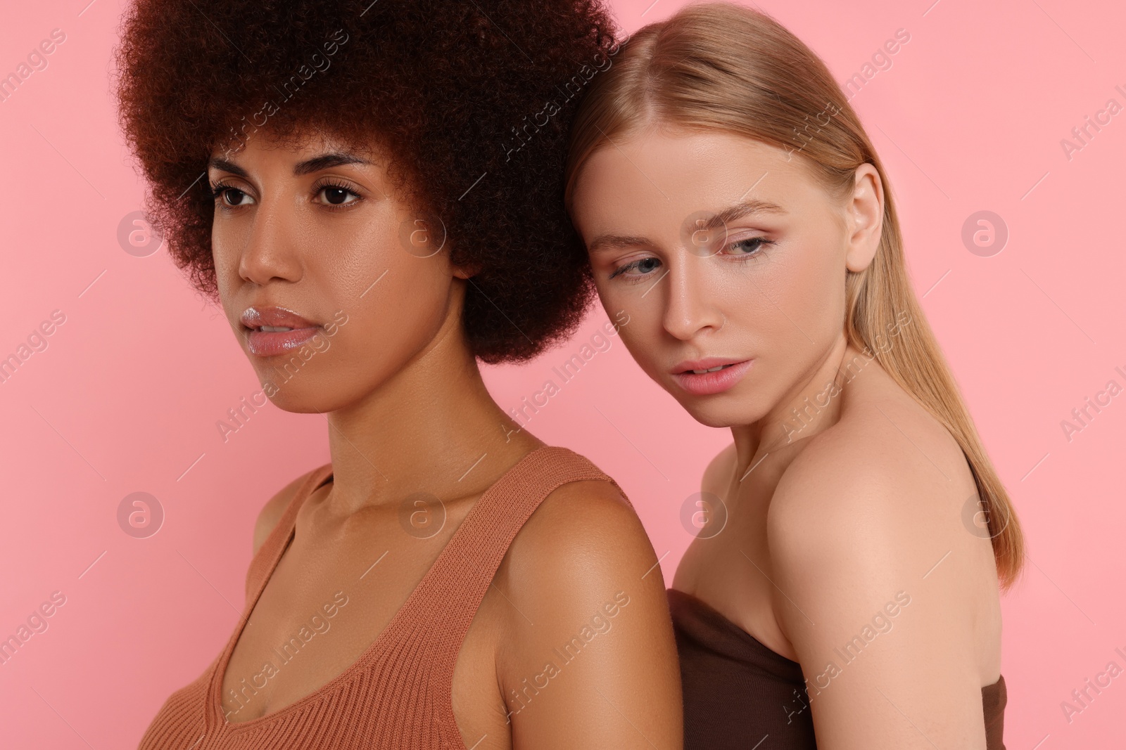 Photo of Portrait of beautiful young women on pink background