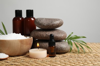 Photo of Beautiful spa composition with bath salt on wicker mat
