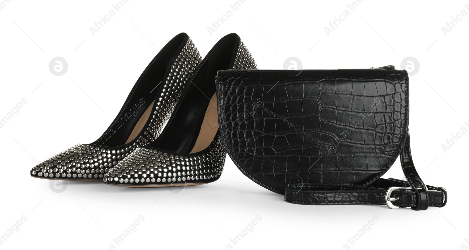 Photo of Black women's saddle bag and high heeled shoes on white background