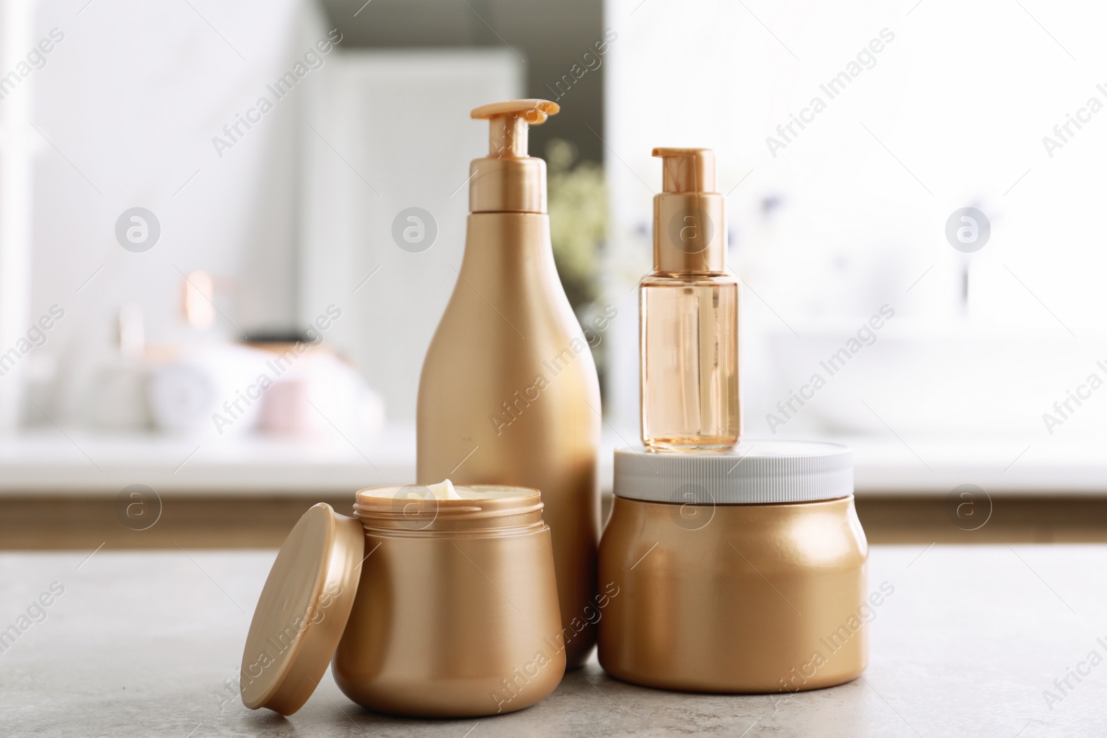 Photo of Different hair care products on table in bathroom