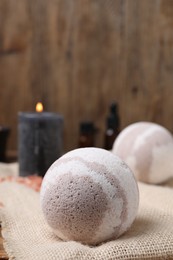 Bath bomb on table, closeup. Space for text