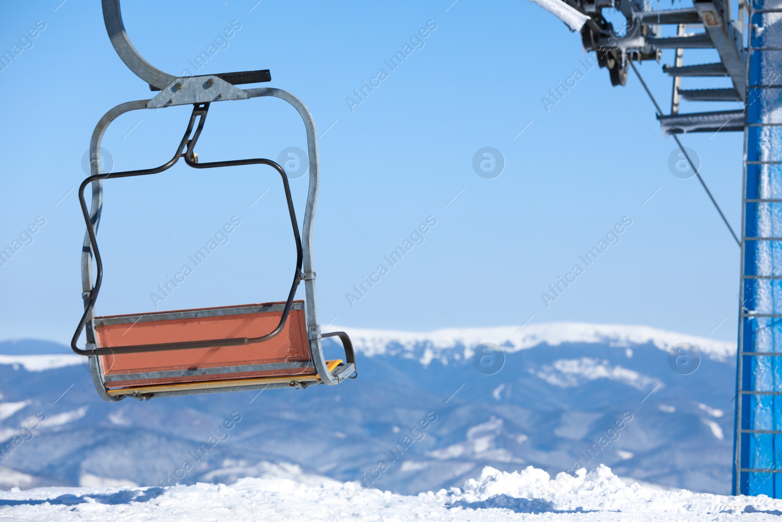 Photo of Empty chairlift at mountain ski resort, space for text. Winter vacation