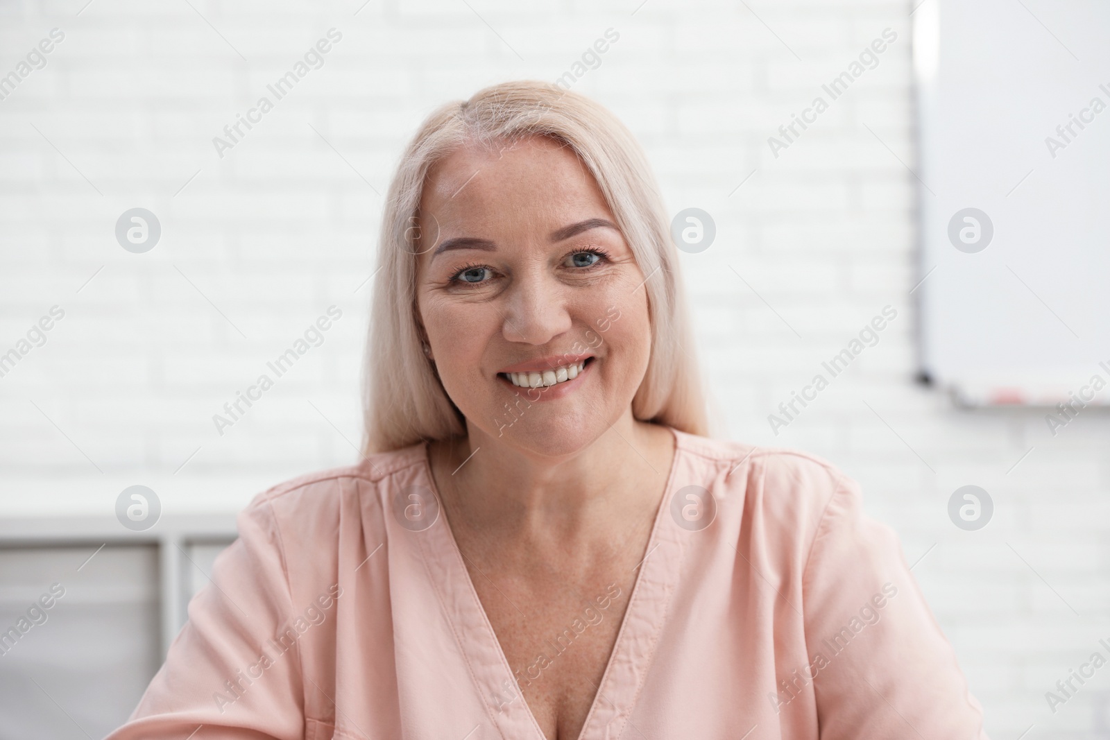 Photo of Mature woman using video chat in office, view from web camera