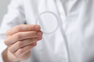 Photo of Doctor holding diaphragm vaginal contraceptive ring, closeup