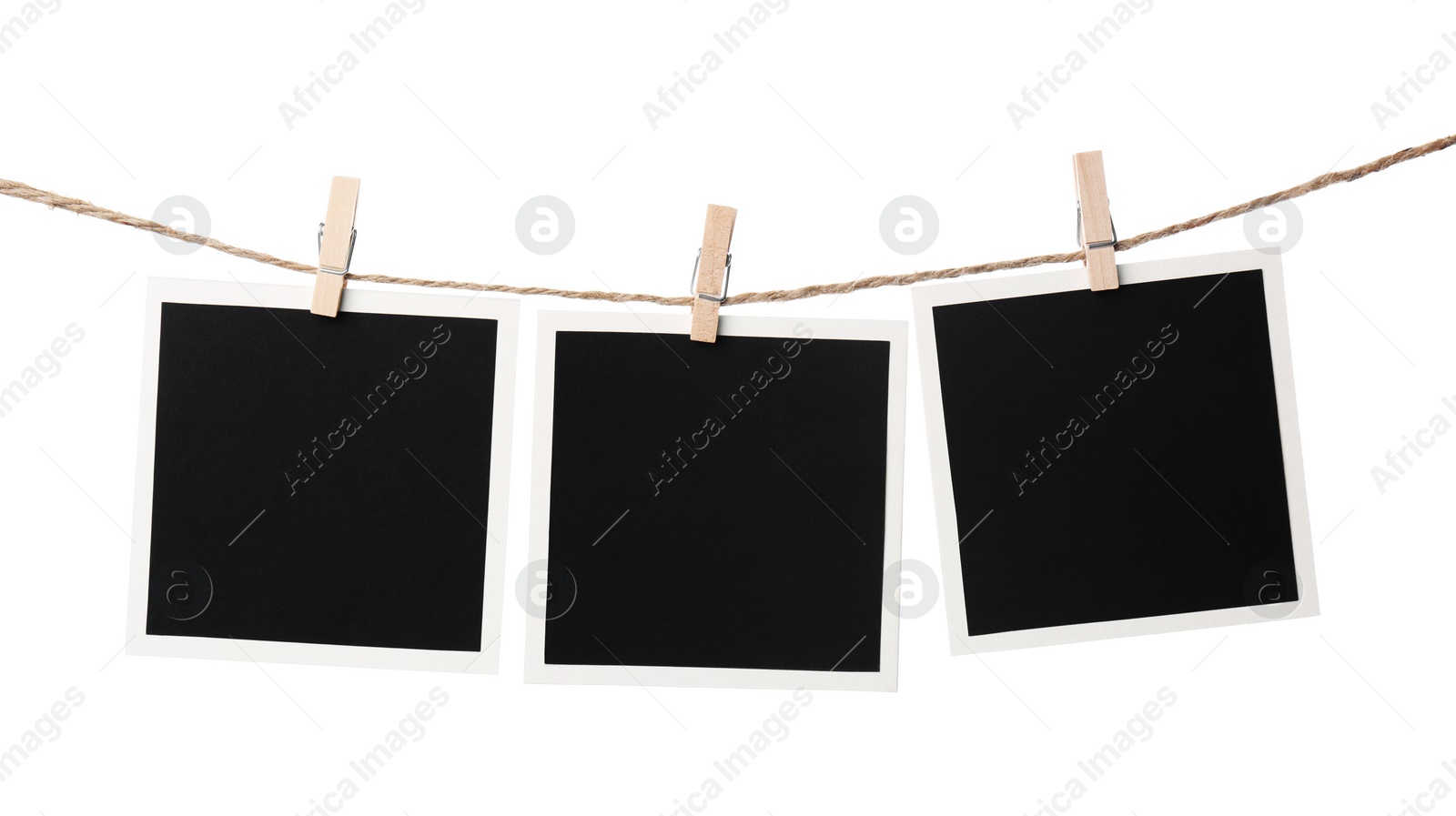 Photo of Clothespins with empty instant frames on string against white background. Space for text