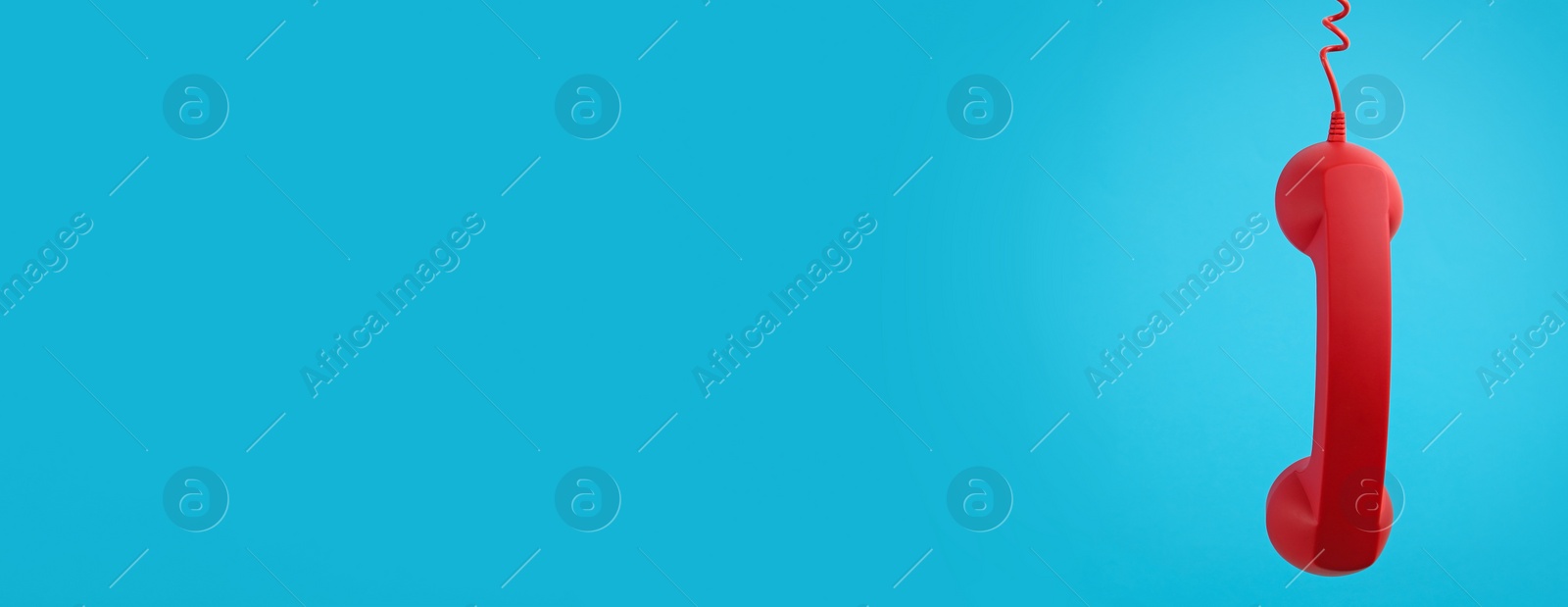 Image of Hotline service. Red telephone receiver and space for text on light blue background, banner design