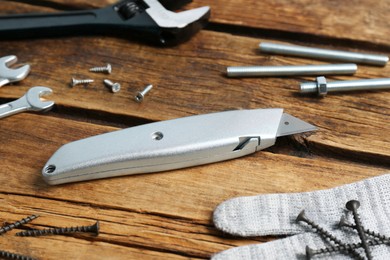Photo of Utility knife and different tools on wooden table