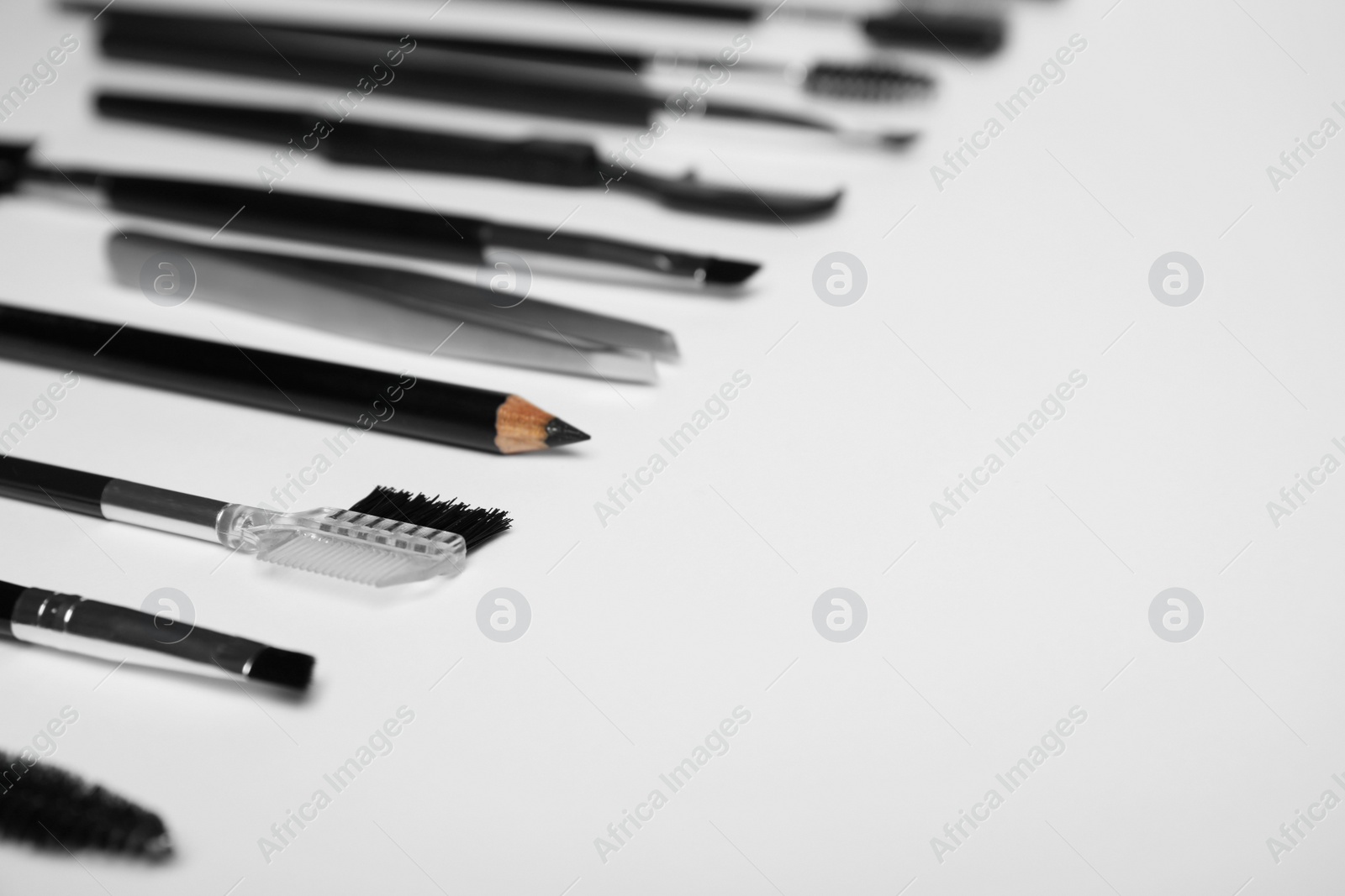 Photo of Set of professional eyebrow tools on white background. Space for text