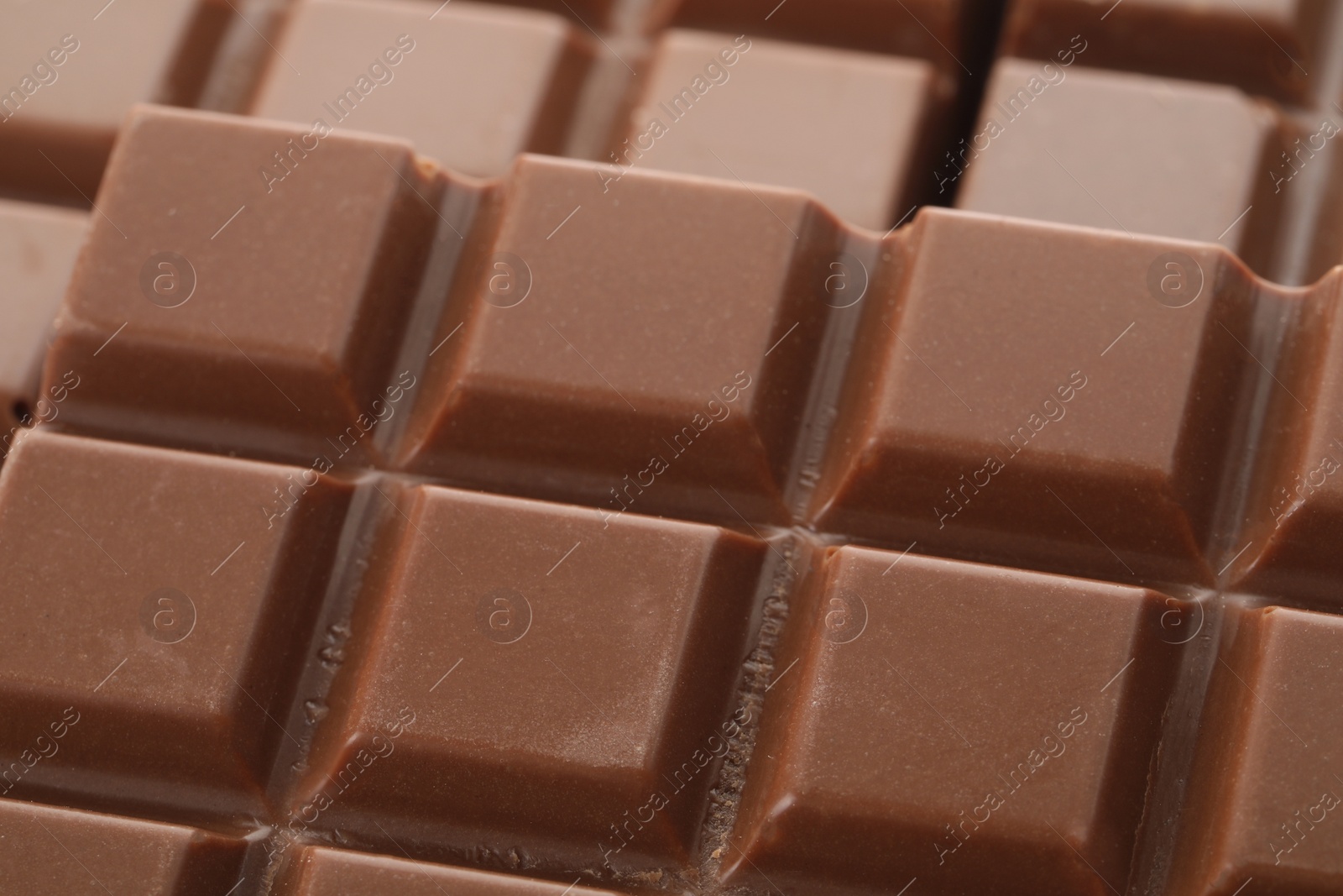 Photo of Delicious milk chocolate as background, closeup view