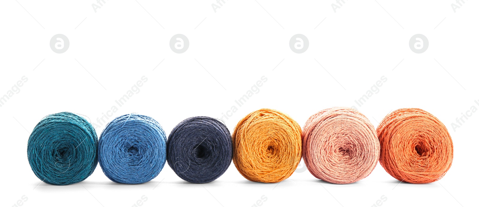 Photo of Clews of colorful knitting threads in row on white background