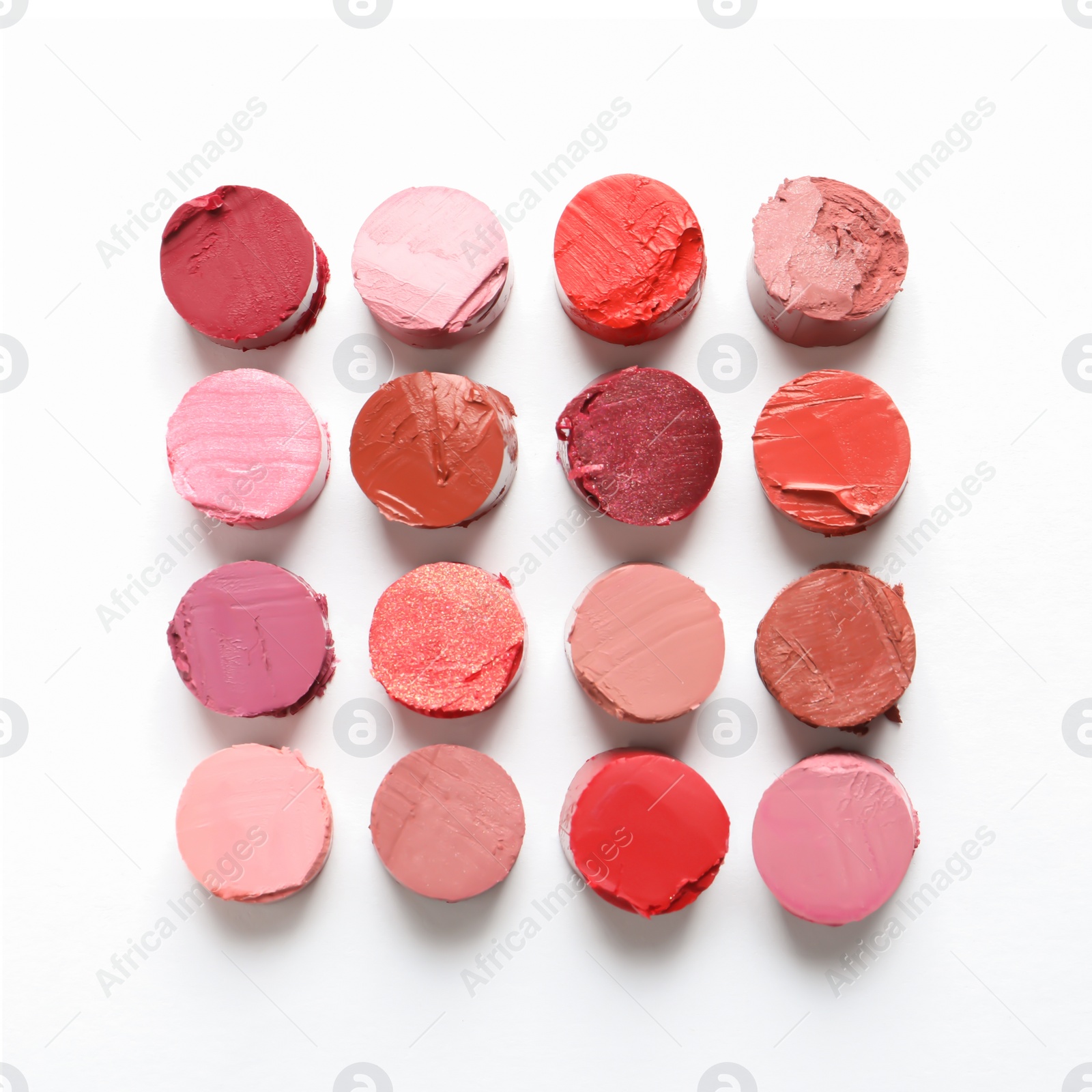 Photo of Different lipstick swatches on white background, top view