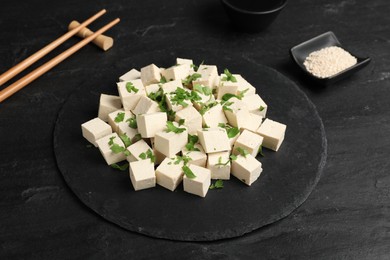 Photo of Delicious tofu with parsley on black table