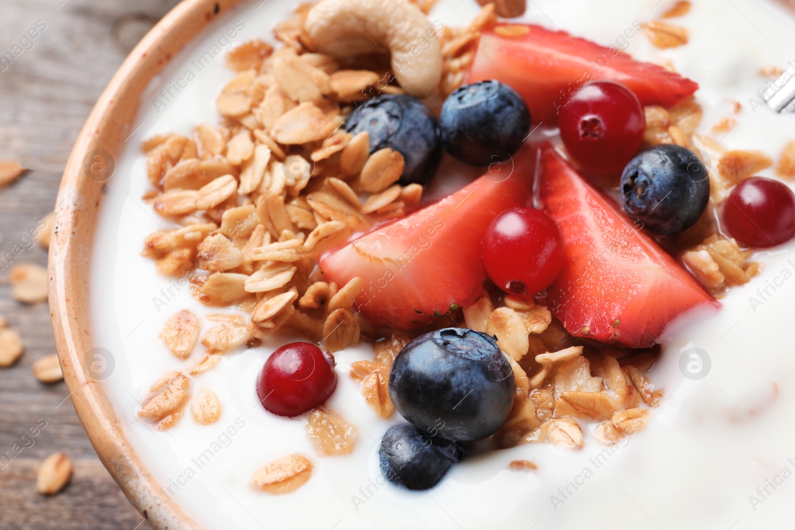 Photo of Bowl with yogurt, berries and granola, closeup