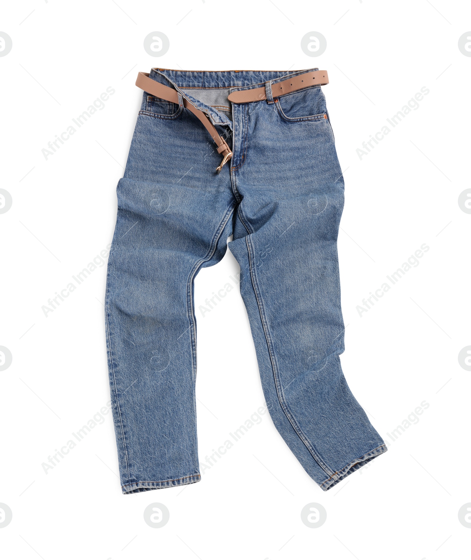 Photo of Rumpled blue jeans with belt isolated on white, top view. Stylish clothes