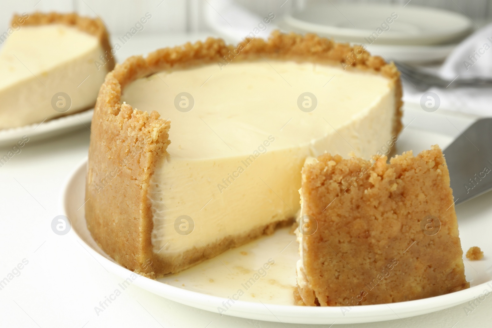 Photo of Tasty vegan tofu cheesecake on white table, closeup