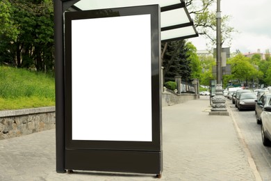 Photo of Blank advertising board on bus stop. Space for design