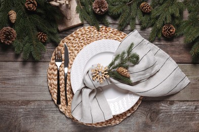 Photo of Luxury place setting with beautiful festive decor for Christmas dinner on wooden table, flat lay