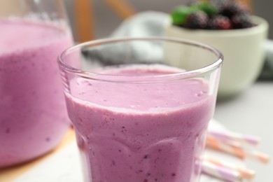 Photo of Delicious blackberry smoothie in glass, closeup view