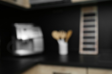 Photo of Blurred view of kitchen interior with modern furniture