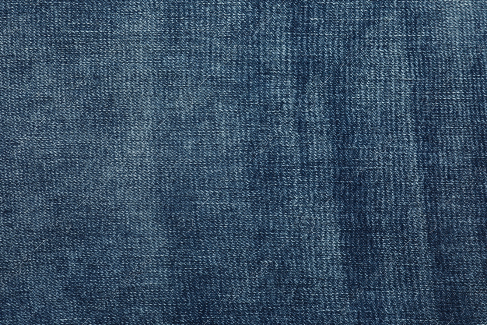 Photo of Texture of dark blue jeans as background, closeup