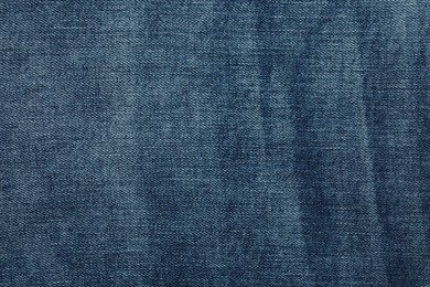 Photo of Texture of dark blue jeans as background, closeup