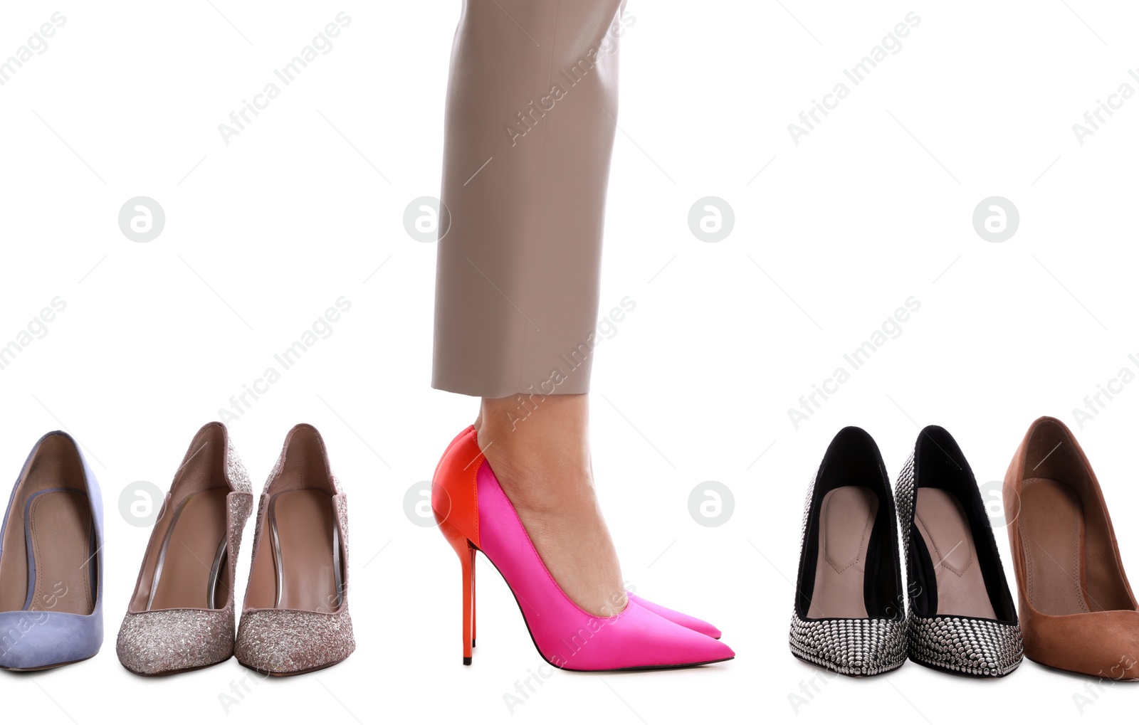 Photo of Fashionable woman with many different high heel shoes on white background, closeup