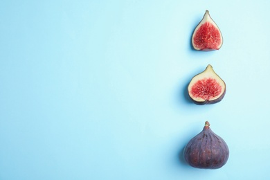 Photo of Delicious ripe figs on light blue background, flat lay. Space for text