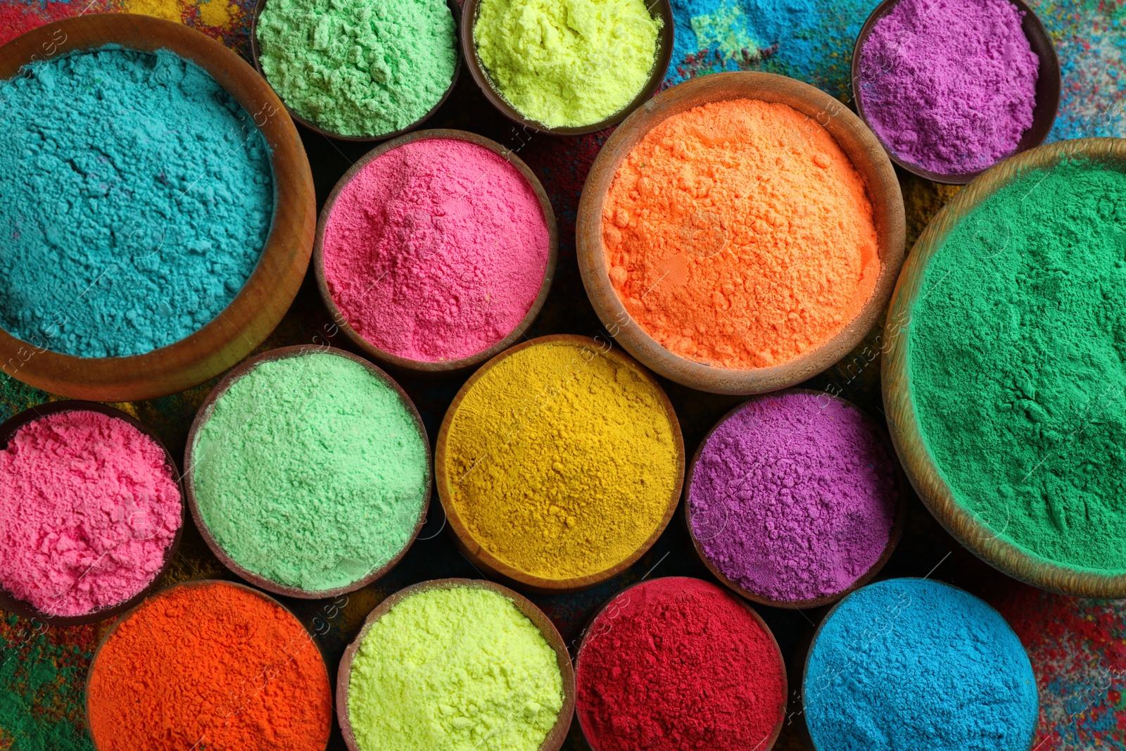 Photo of Colorful powder dyes as background, top view. Holi festival