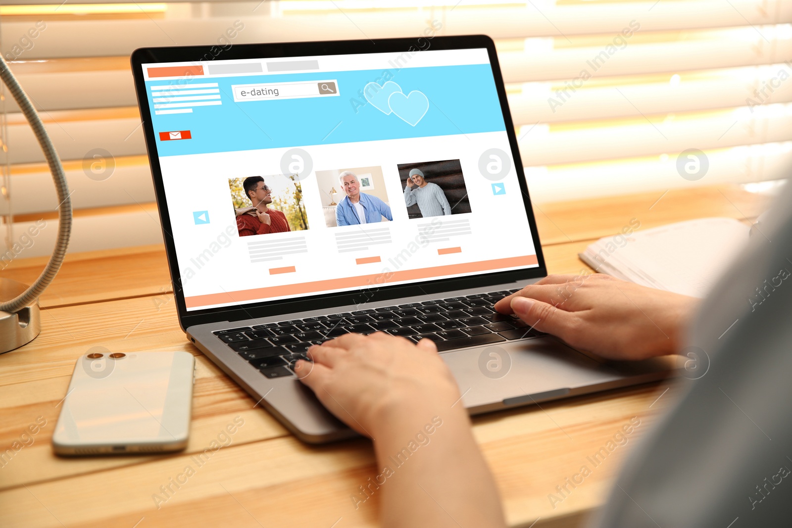 Image of Young woman visiting online dating site via laptop at table, closeup