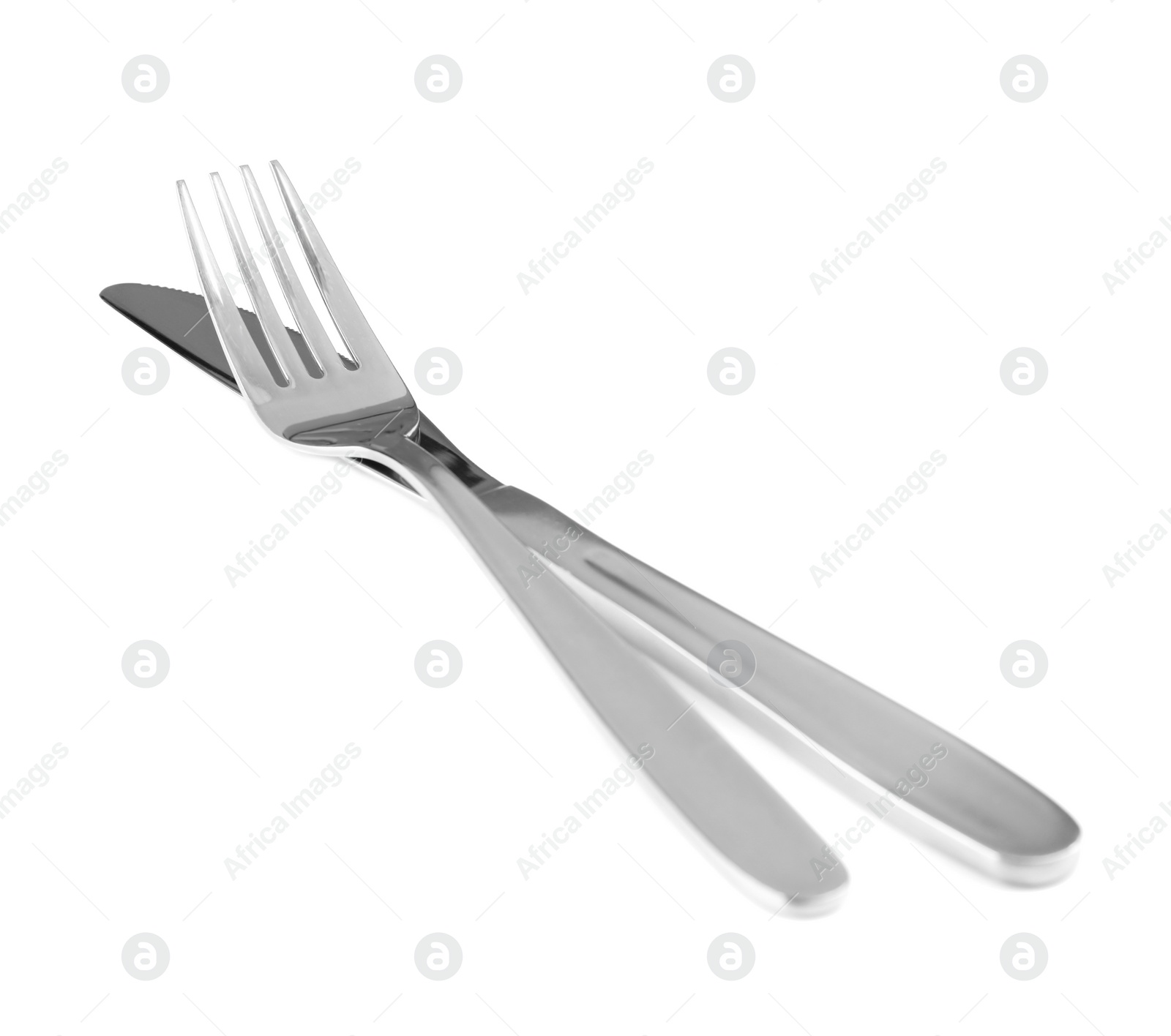 Photo of Shiny fork and knife on white background