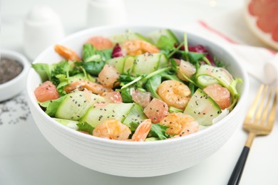 Photo of Delicious pomelo salad with shrimps served on white  table, closeup