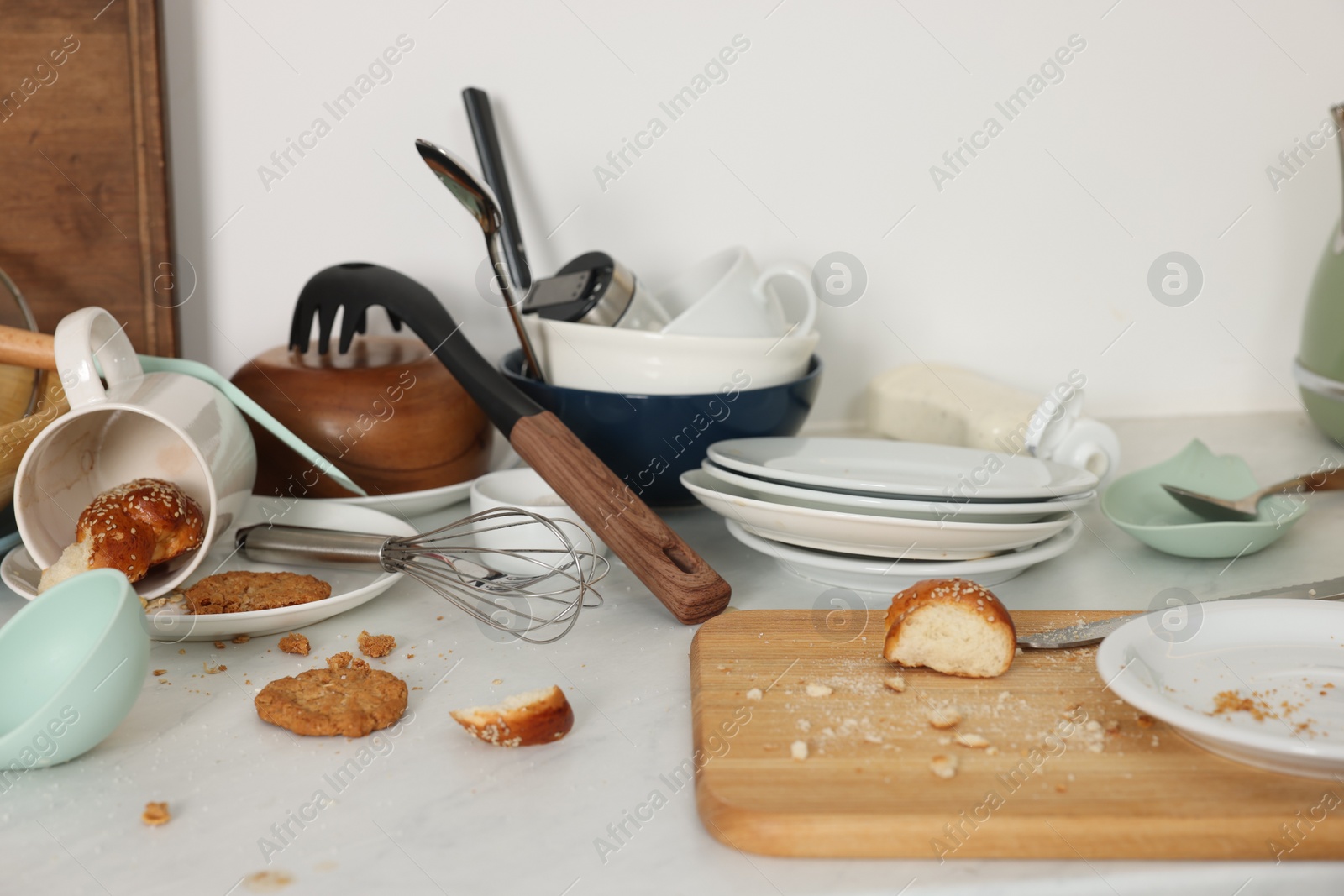 Photo of Many dirty utensils, dishware and food leftovers on white countertop. Mess in kitchen
