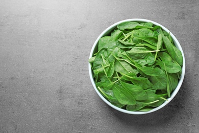 Fresh green healthy spinach on grey table, top view. Space for text