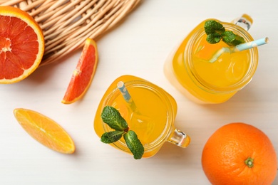 Photo of Delicious orange soda water on white wooden table, flat lay