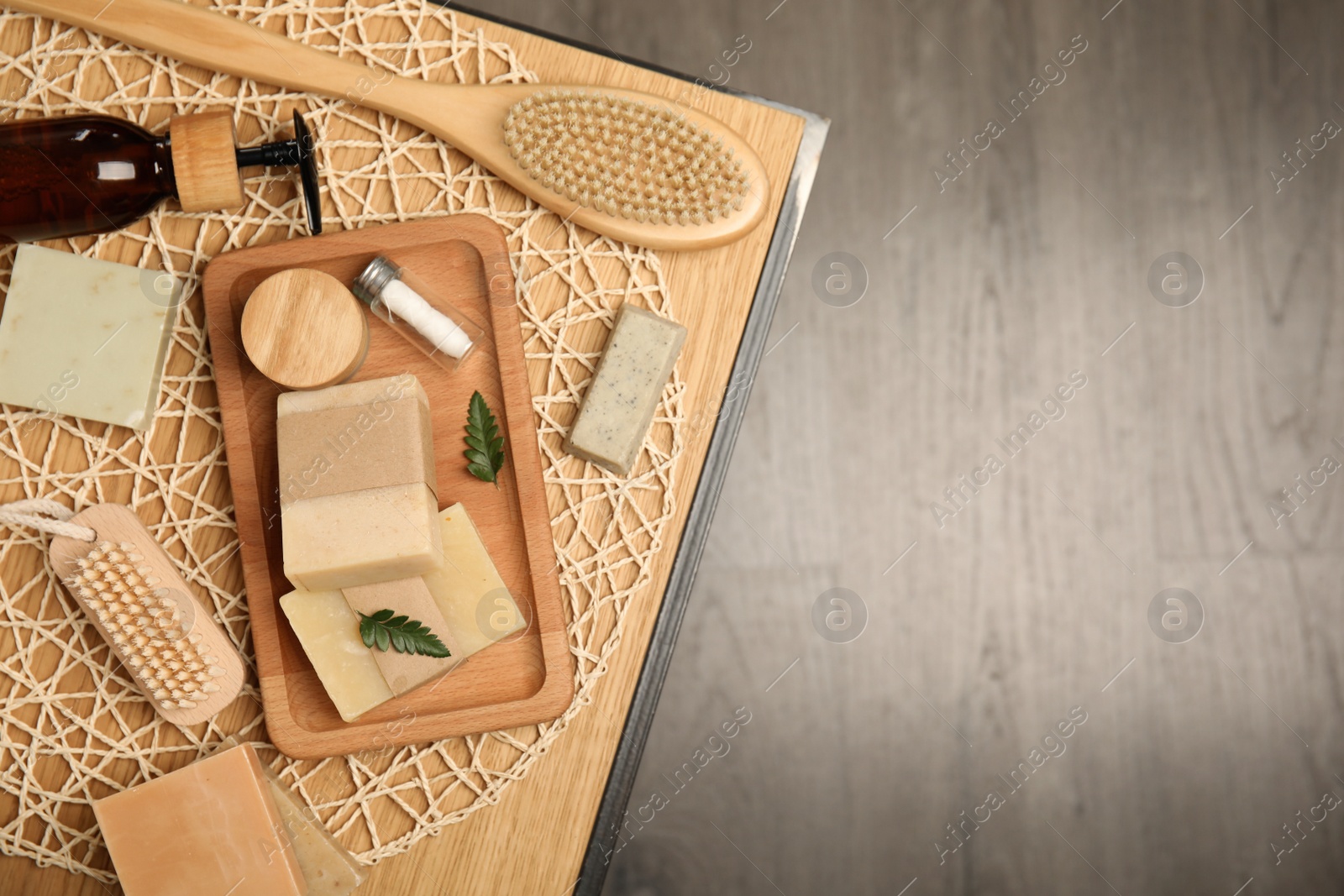 Photo of Eco friendly personal care products on wooden table, top view. Space for text