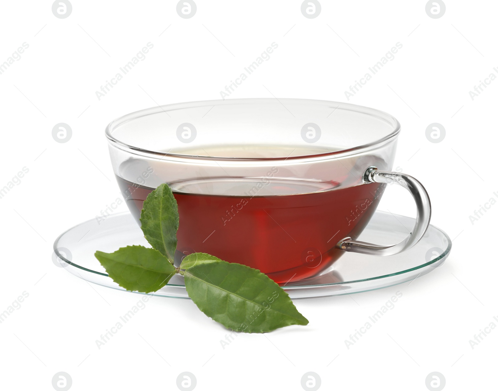 Photo of Glass cup of hot aromatic tea and green leaves on white background